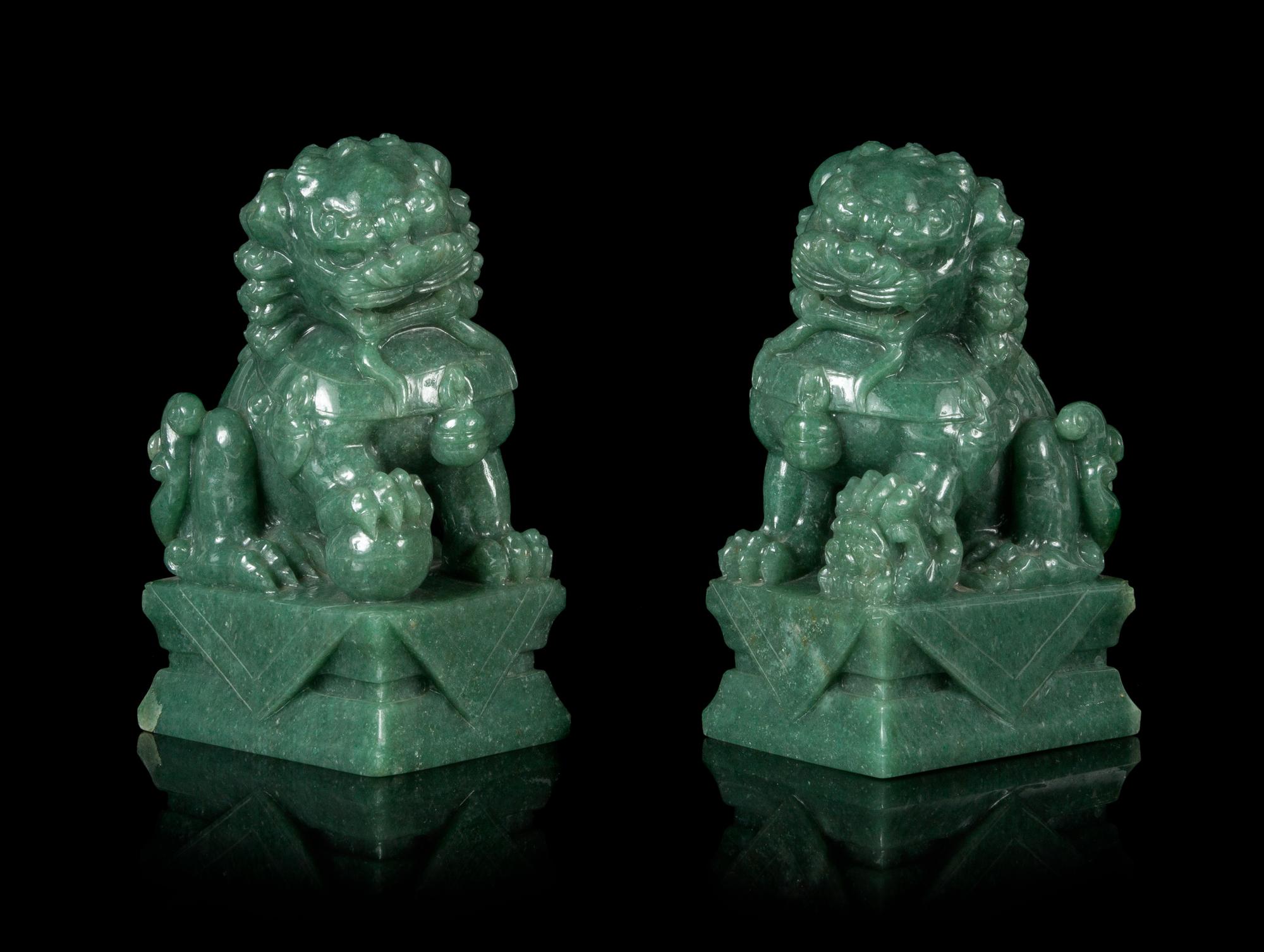 A Pair of Chinese Green Jade Figures of Fu Lions Height 6 1/4 inches. — 20TH CENTURY