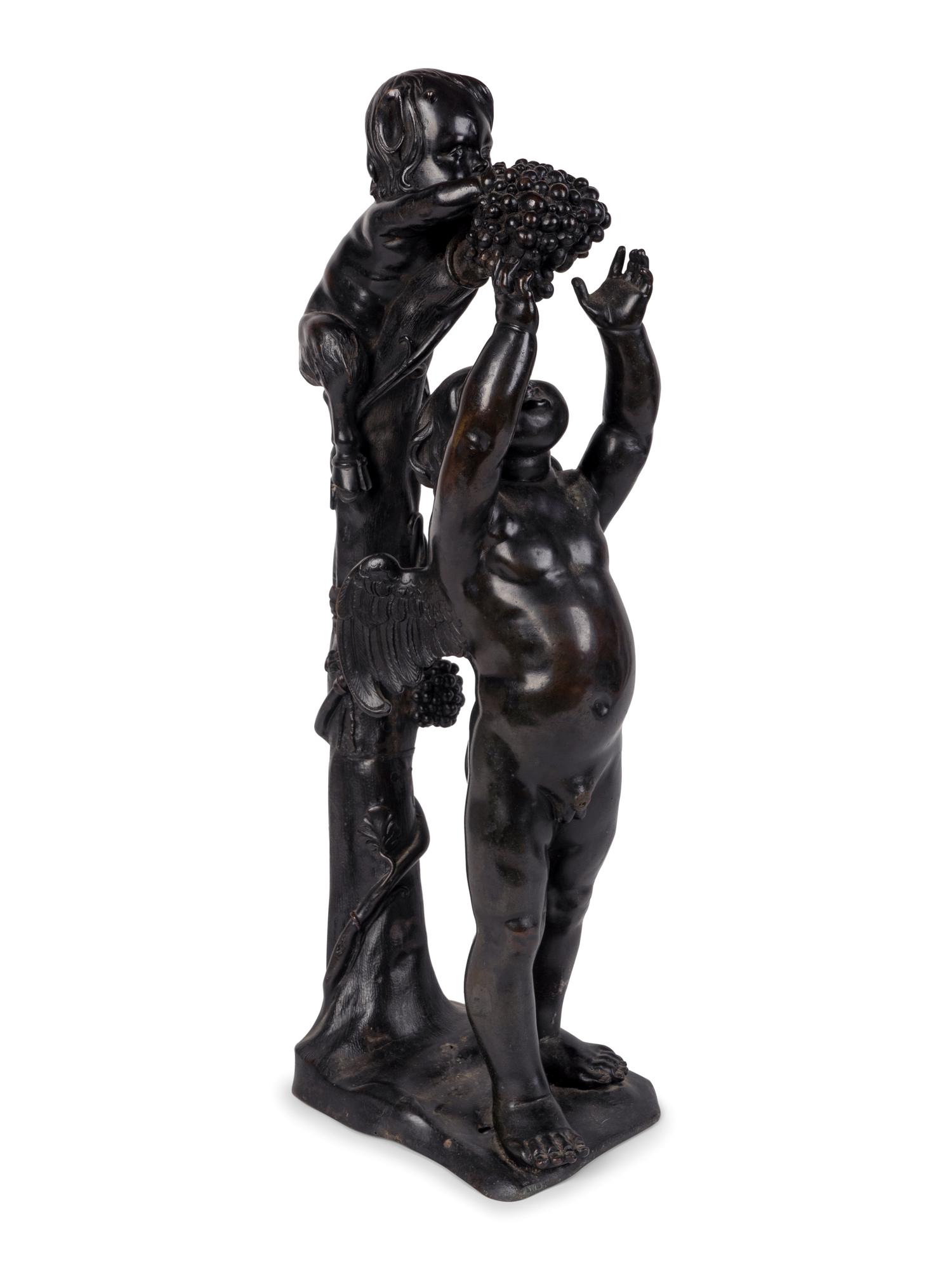 A Continental Patinated Bronze Group of Cupid and an Infant Satyr — CIRCA 1900