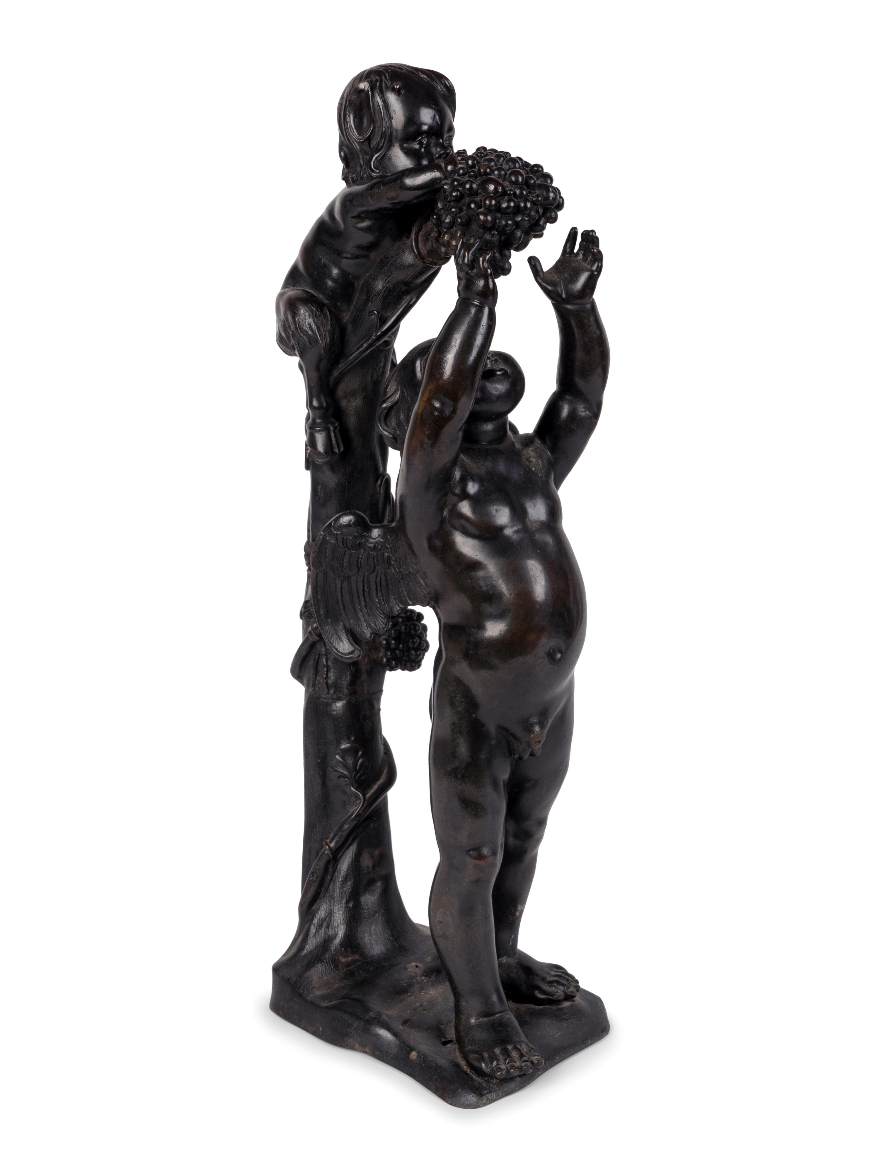A Continental Patinated Bronze Group of Cupid and an Infant Satyr — CIRCA 1900