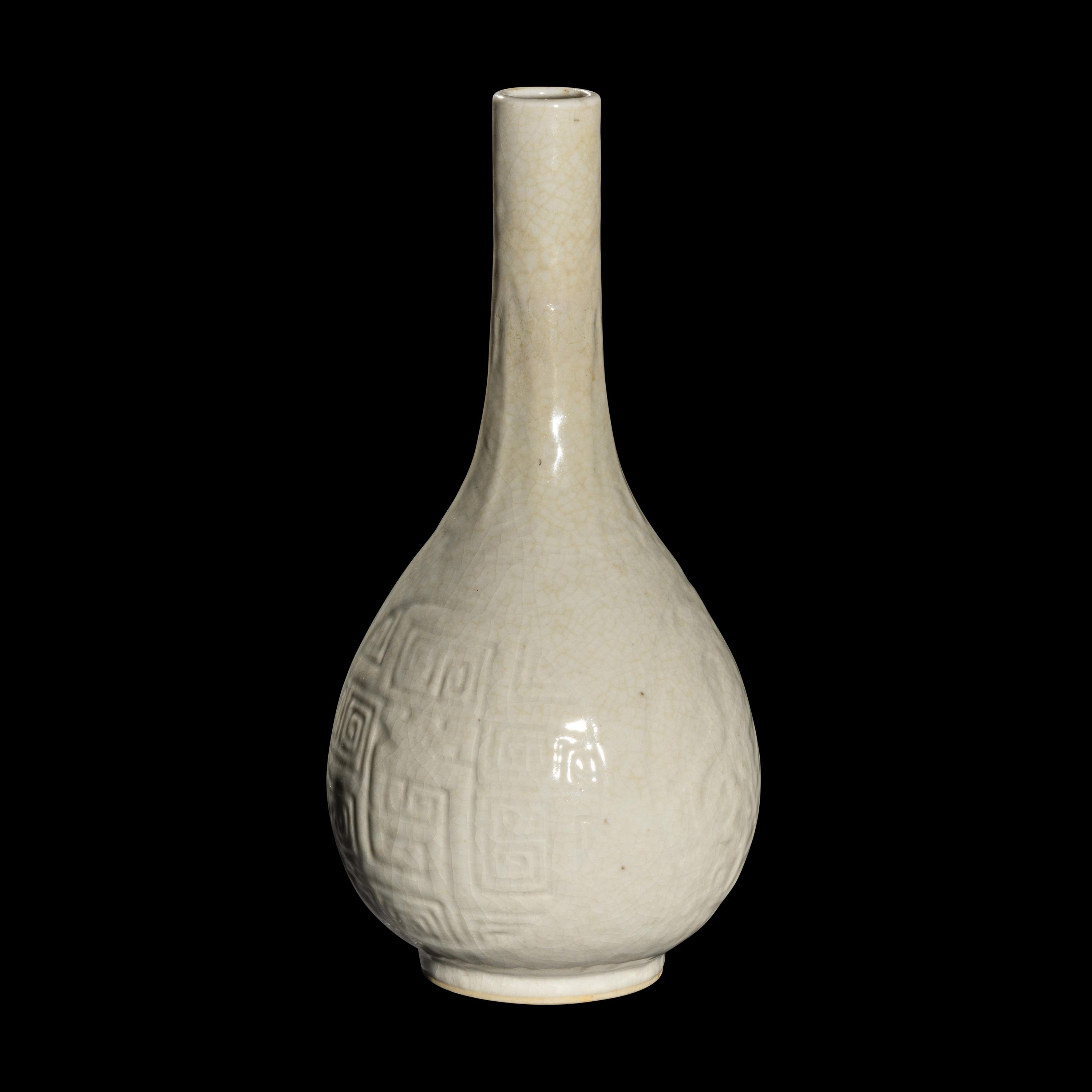A Chinese Molded White Glazed Porcelain Bottle Vase, 18th/19th Century 清中期 白釉模印如意纹膽瓶