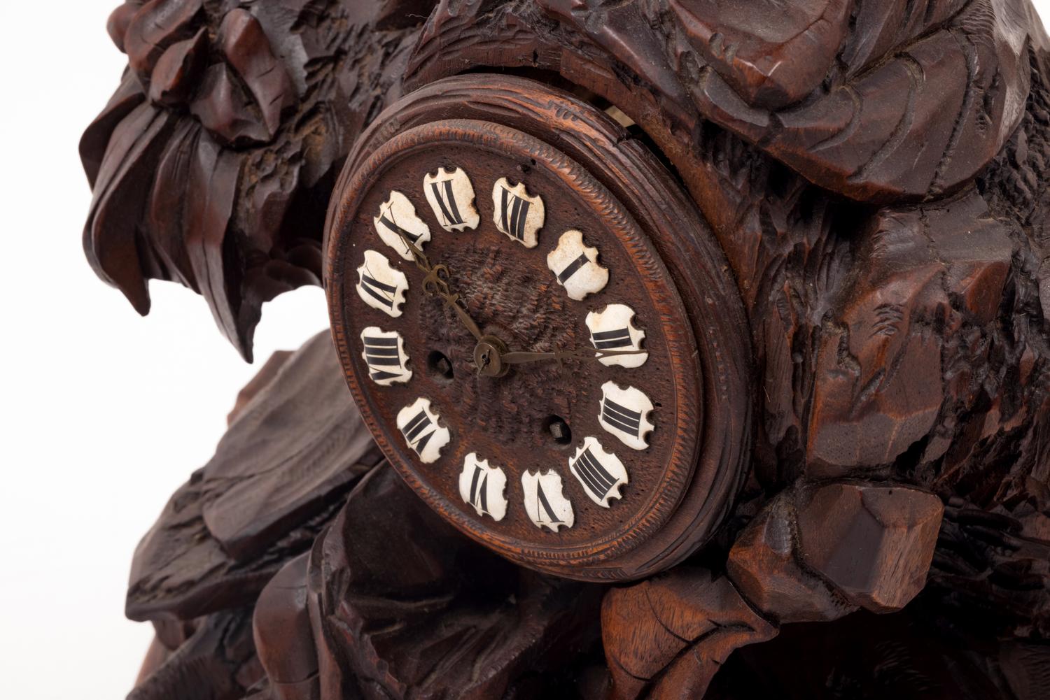A Black Forest Carved Clock Garniture