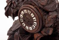 A Black Forest Carved Clock Garniture