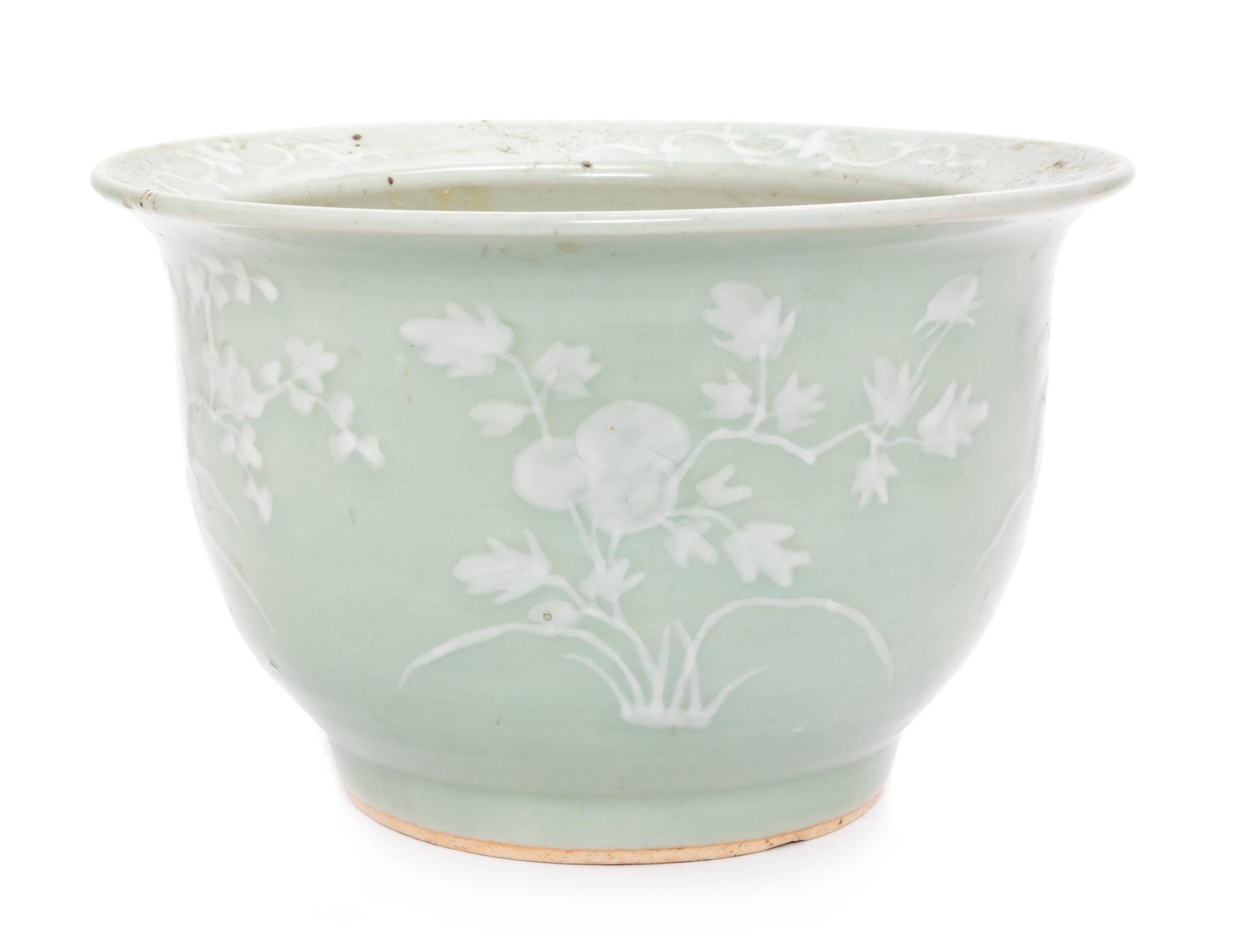 A Chinese White Slip Decorated Celadon Ground Cachepot Height 11 1/2 inches.