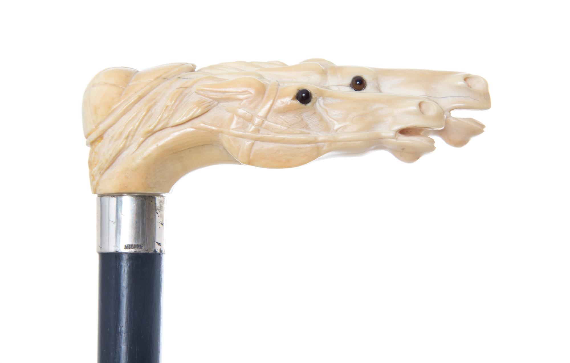 A Carved Ivory Cane, Length of handle 4 1/2 x length overall 39 inches.