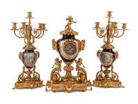 A Louis XVI Style Gilt Bronze and Sèvres Style Porcelain Clock Garniture