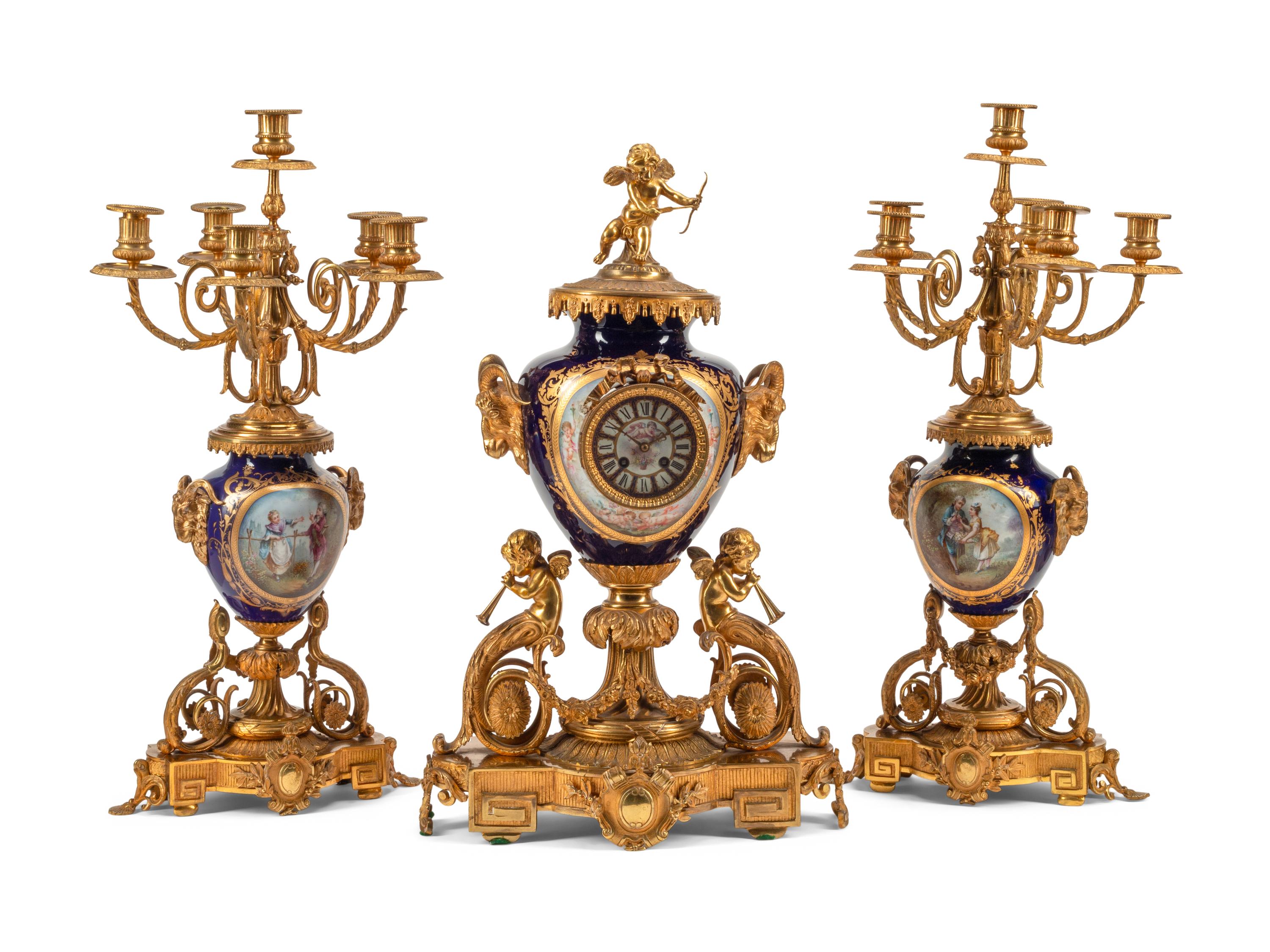 A Louis XVI Style Gilt Bronze and Sèvres Style Porcelain Clock Garniture