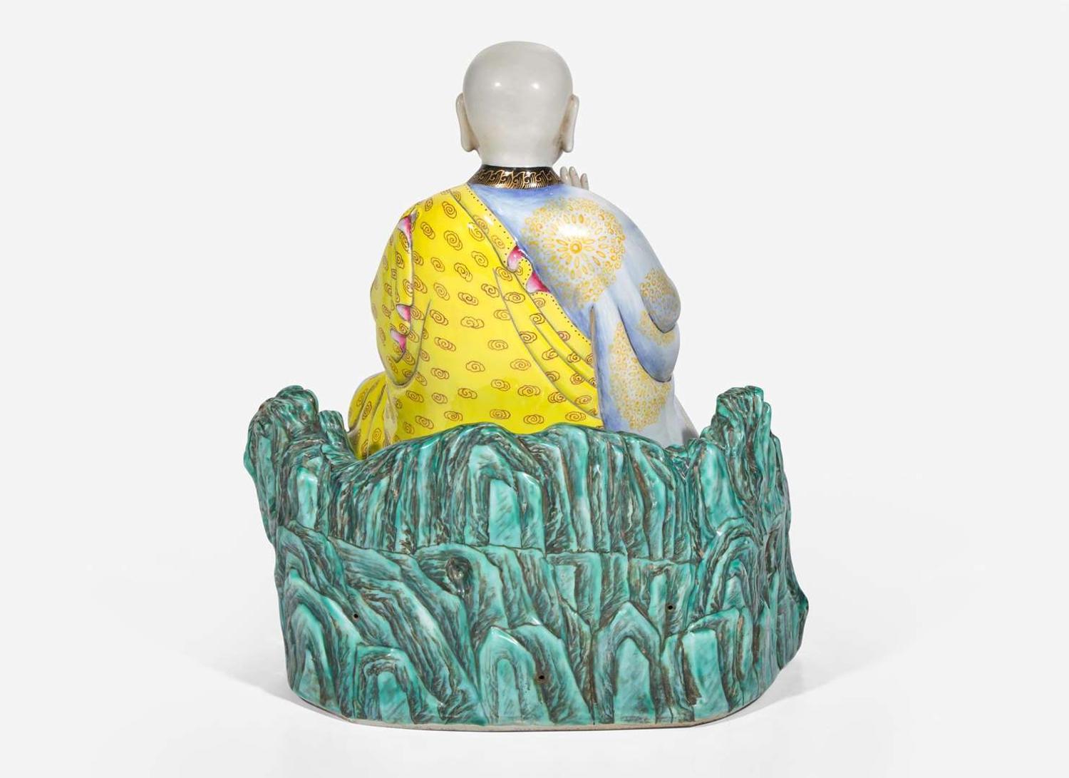 A Chinese famille rose-decorated porcelain figure of a seated lohan 粉彩羅漢坐像