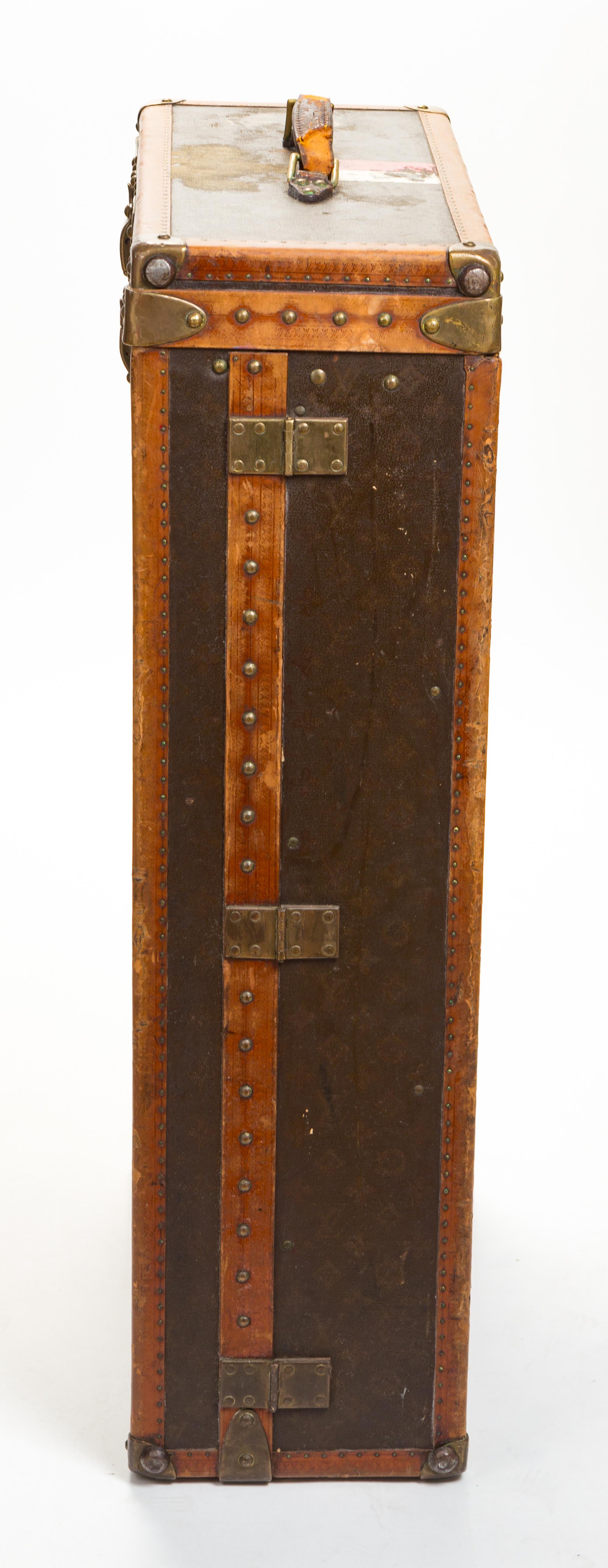 A Louis Vuitton Monogram Leather Wardrobe Trunk, 33.5"H x 21.25"W x 9"D.