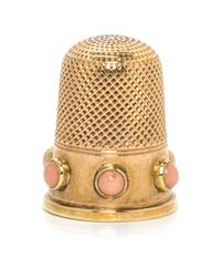 An English Yellow Gold and Coral Thimble, , the knurled top and body above a plain band inset with six coral cabochons.