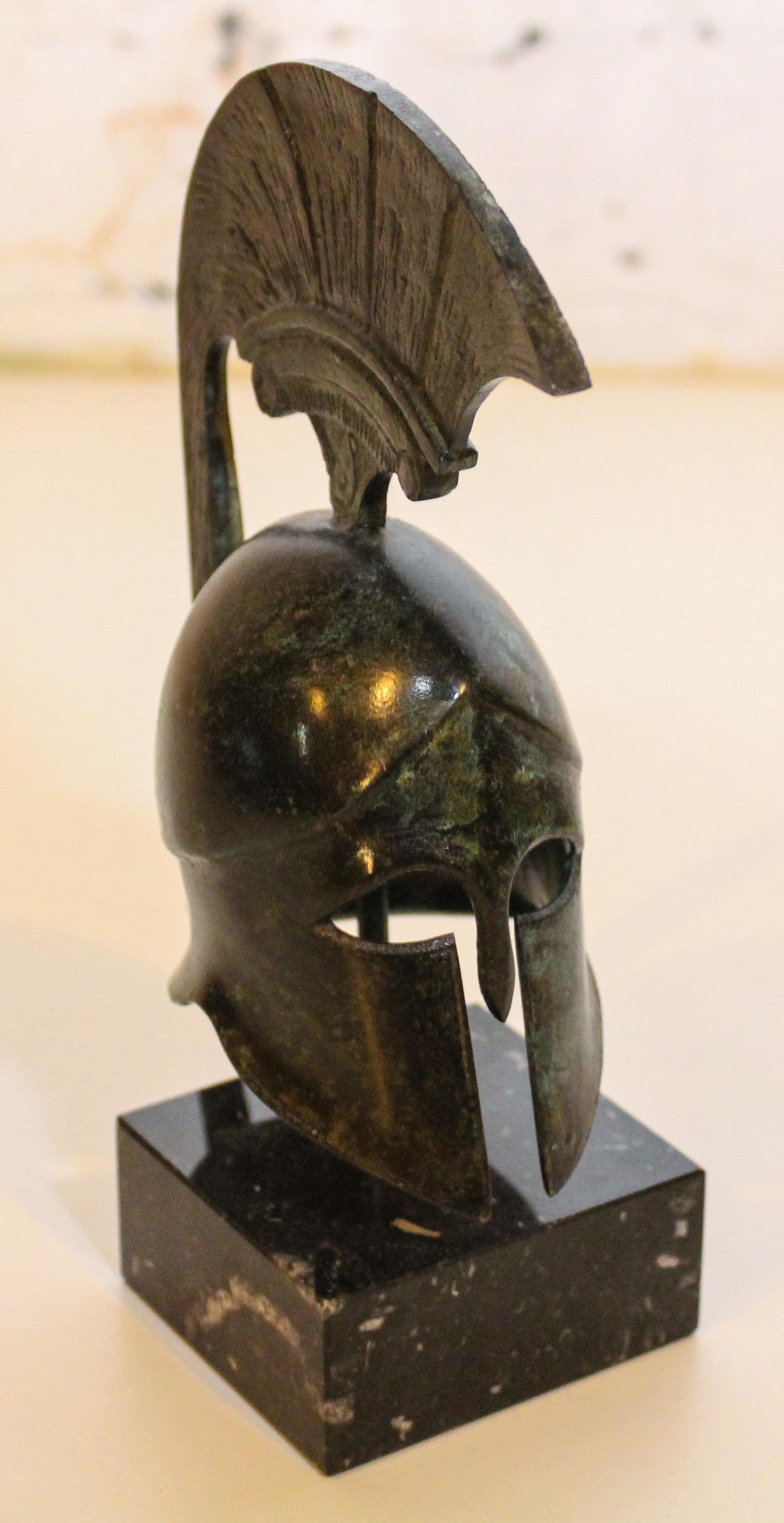 A Cast Metal Grecian Helmet. Height 6 1/4 inches.