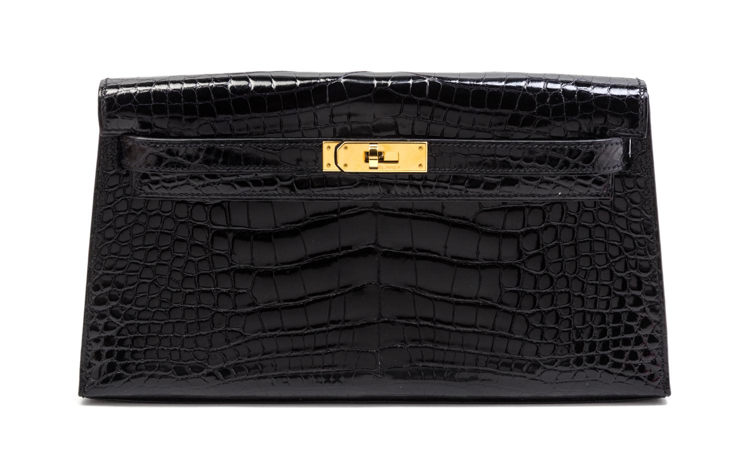 An Hermes Black Shiny Alligator Kelly Clutch Bag, 11 x 6 x 1 1/2 inches.