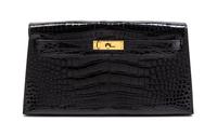 An Hermes Black Shiny Alligator Kelly Clutch Bag, 11 x 6 x 1 1/2 inches.
