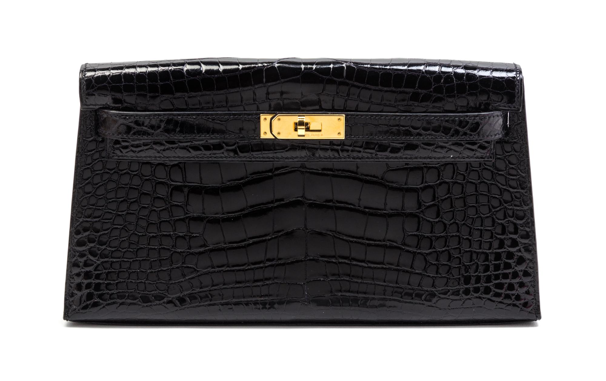 An Hermes Black Shiny Alligator Kelly Clutch Bag, 11 x 6 x 1 1/2 inches.