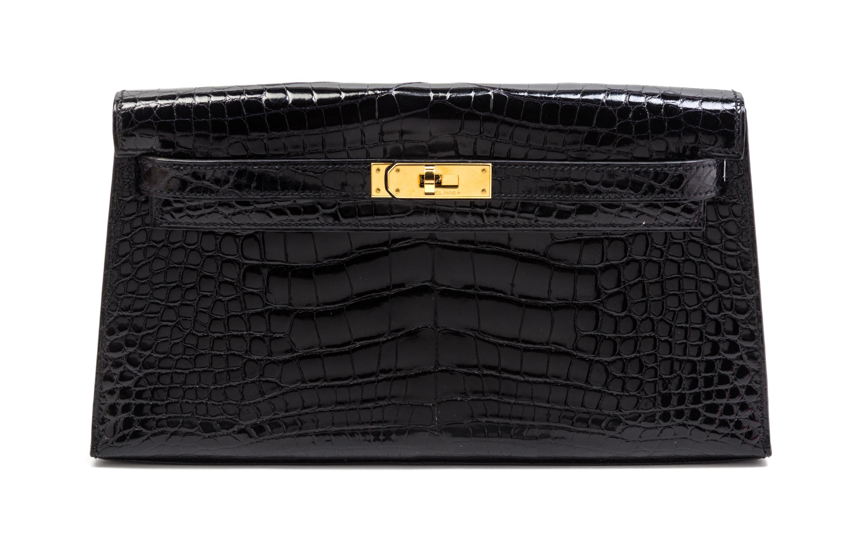 An Hermes Black Shiny Alligator Kelly Clutch Bag, 11 x 6 x 1 1/2 inches.