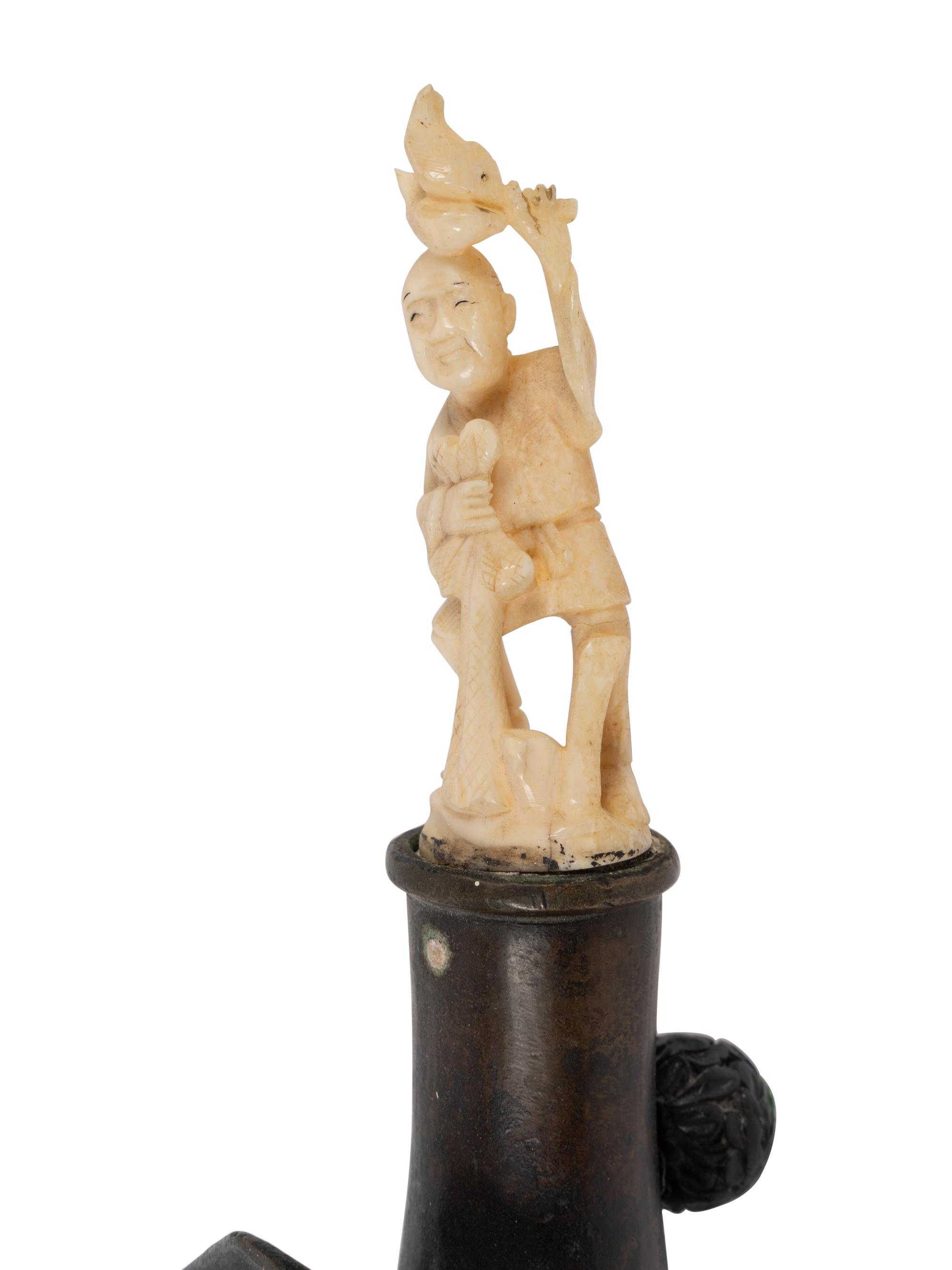 A Chinese Silk Iron with a Figural Handle