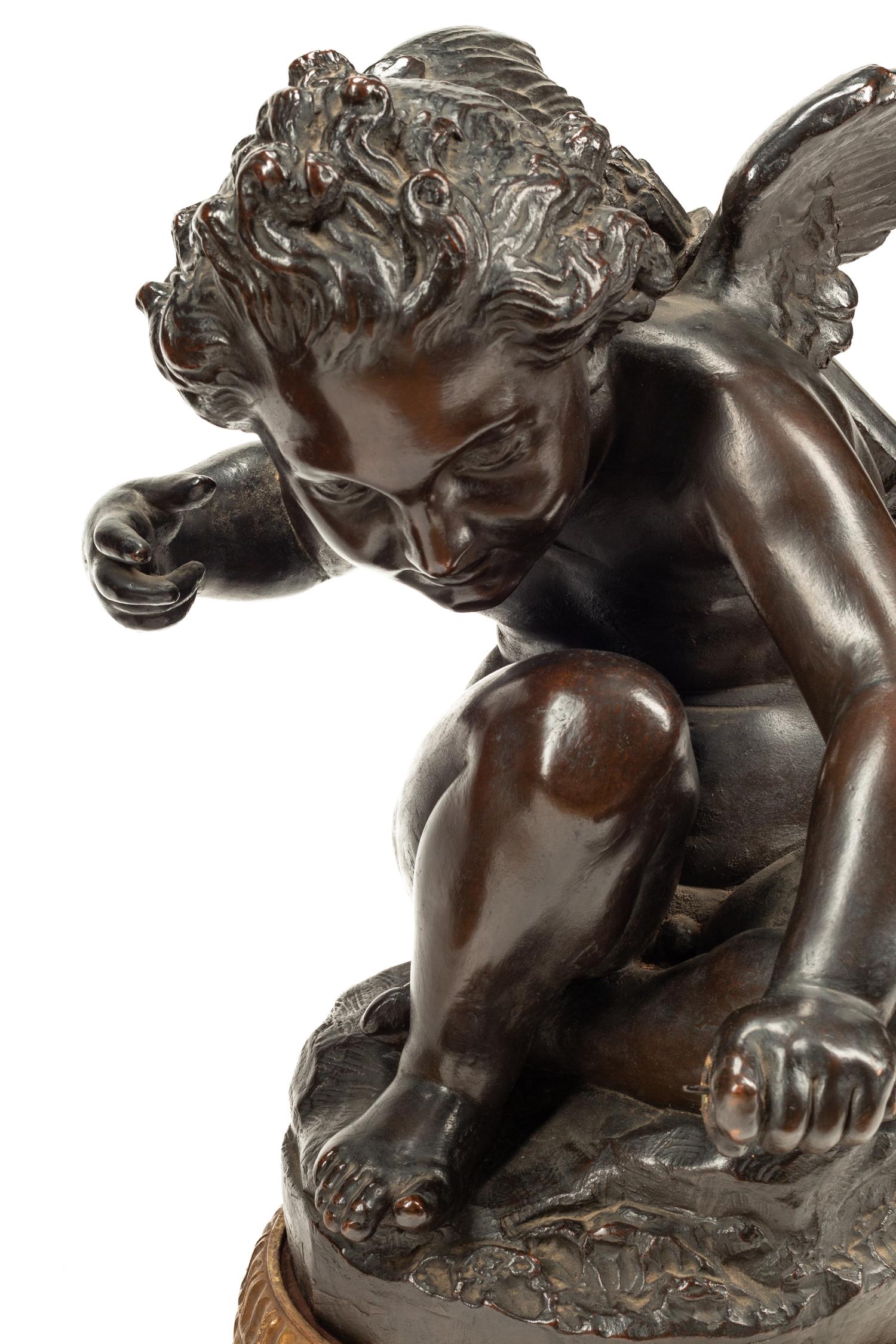 A Pair of Bronzed Composition Figures of Seated Cherubs