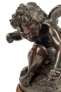 A Pair of Bronzed Composition Figures of Seated Cherubs