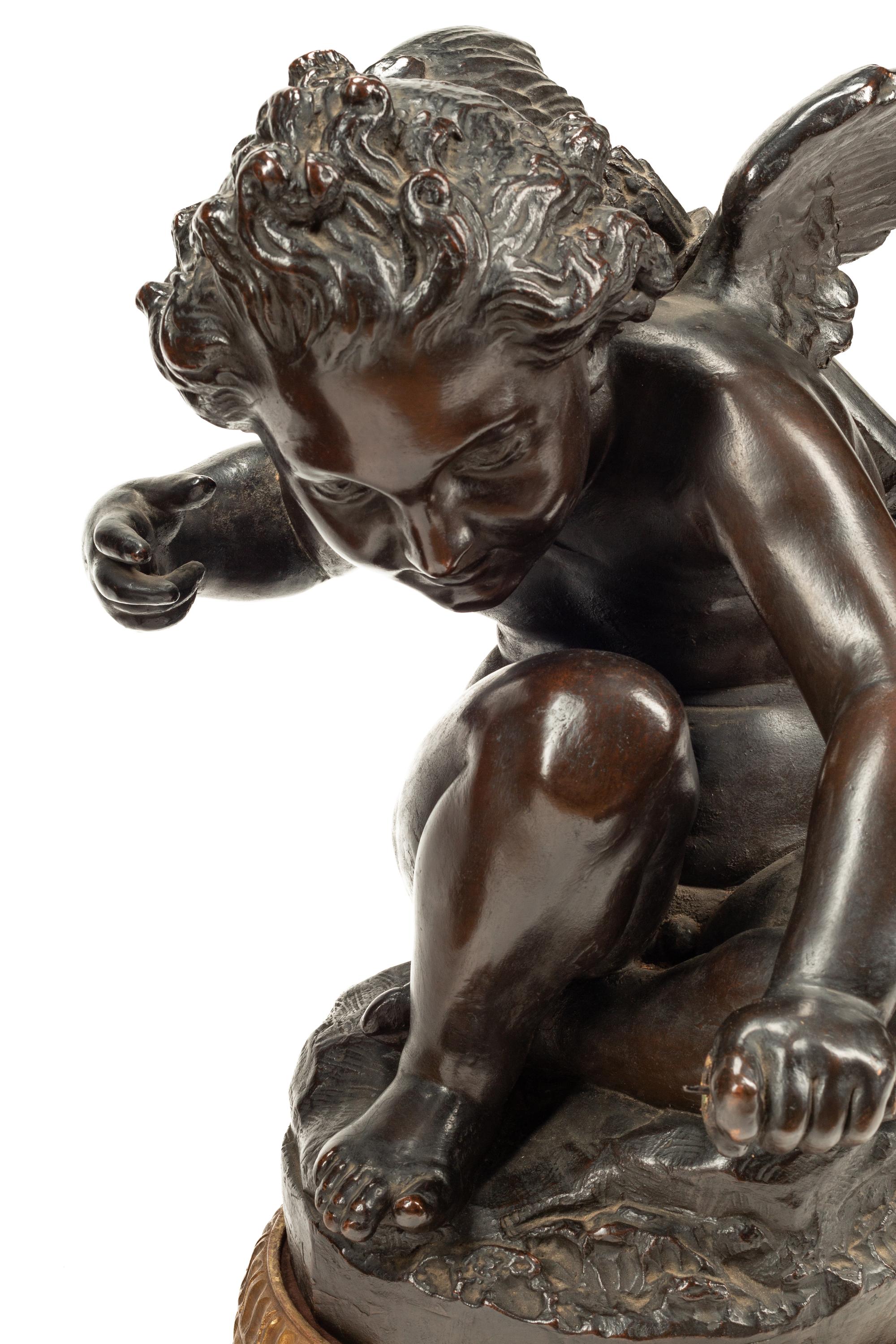 A Pair of Bronzed Composition Figures of Seated Cherubs