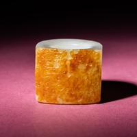 A Chinese Russet and White Jade 'Taotie and Chilong' Archer's Ring, 18th Century — 清中期 白玉留皮饕餮螭龍紋扳指