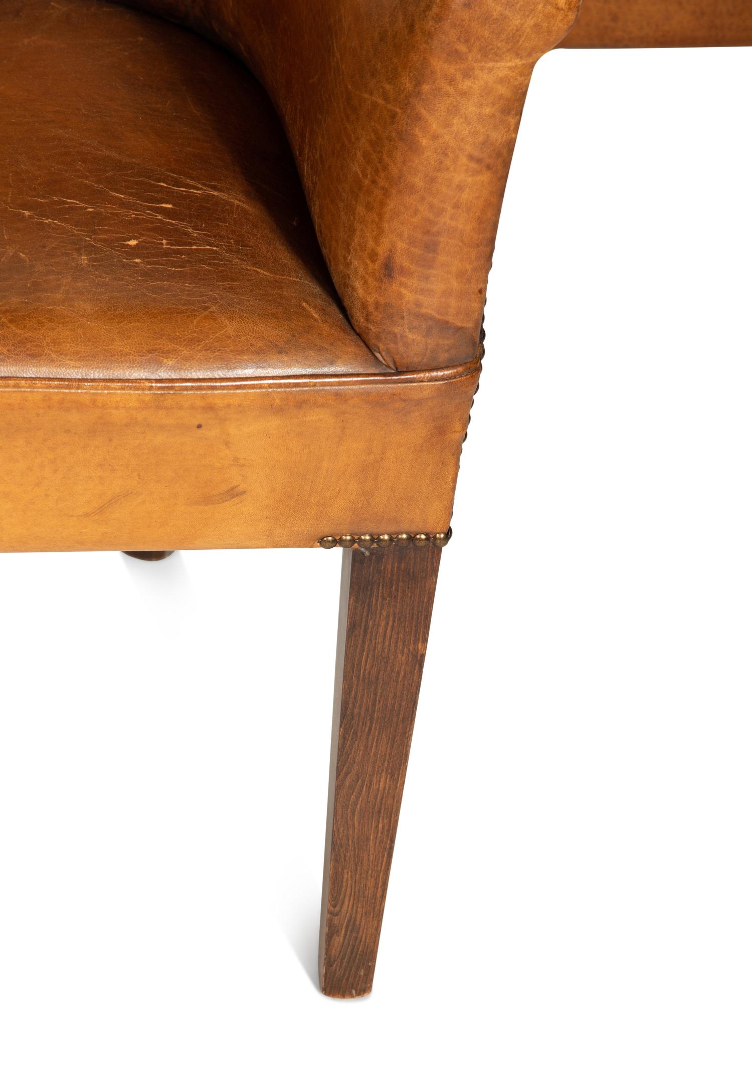 A Set of Four Leather-Upholstered Barrel-Back Armchairs