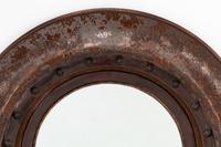 A Pair of Portuguese Embossed Leather Circular Mirrors