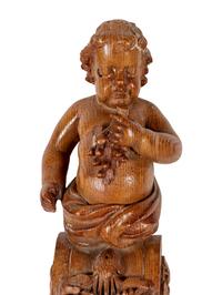 A Continental Carved Oak Figural Bracket in the Form of a Putto
