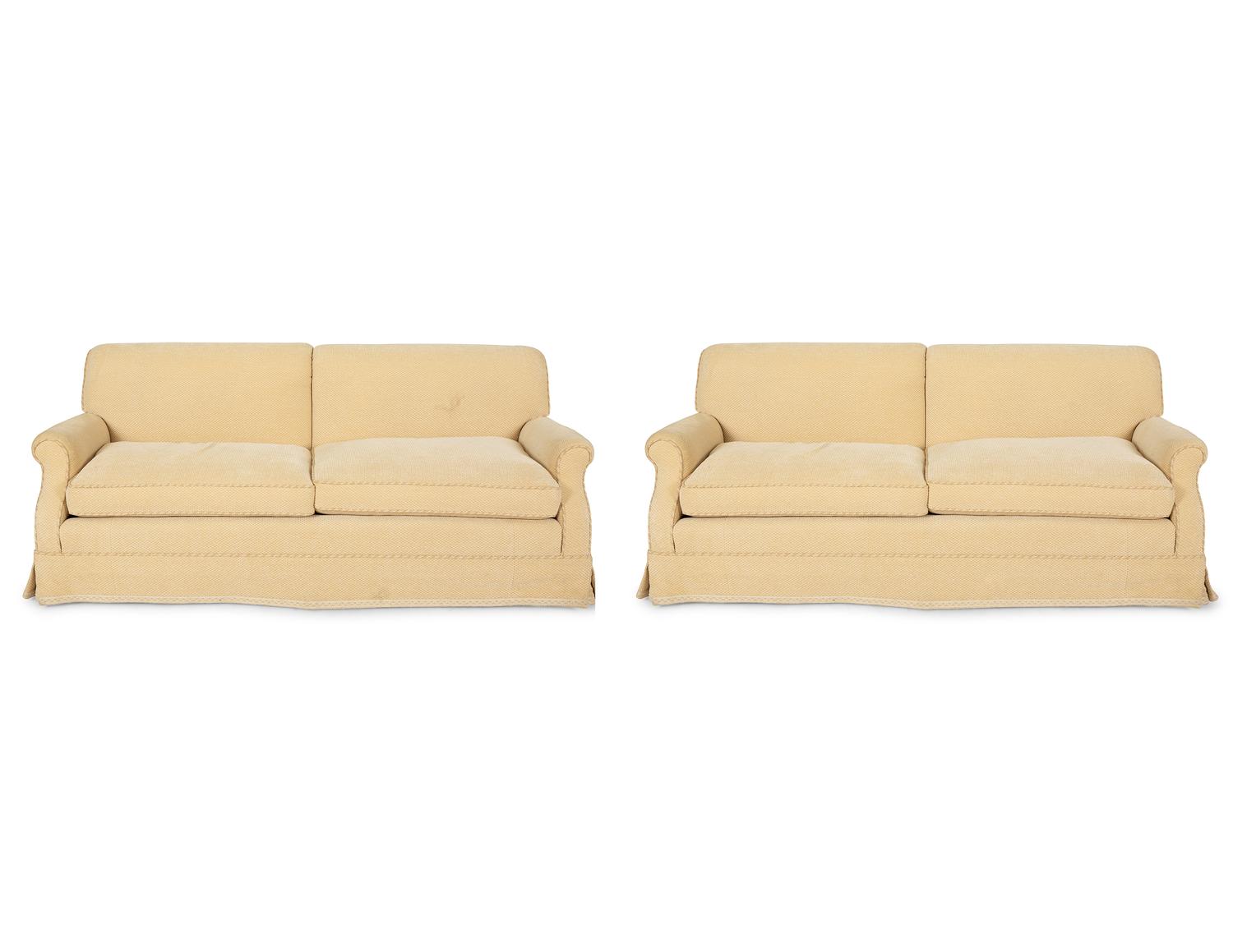 A Pair of Ivory Upholstered Three Cushion Sofas — 20th Century