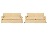A Pair of Ivory Upholstered Three Cushion Sofas — 20th Century