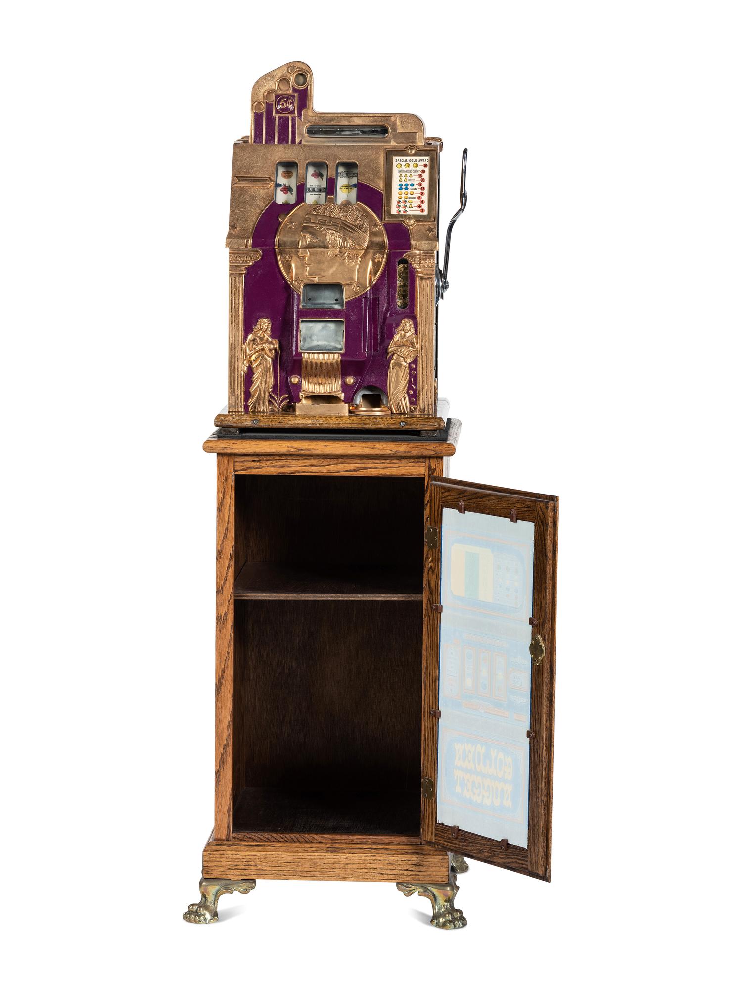A Mills 5 Cent Special Gold Roman Head Slot Machine on Reverse Printed Glass Inset Golden Nugget Stand
