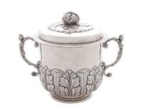 An English Silver Covered Sugar, London, 1917, with applied S-scroll handles, an open acanthus finial and a band of acanthus rising fro