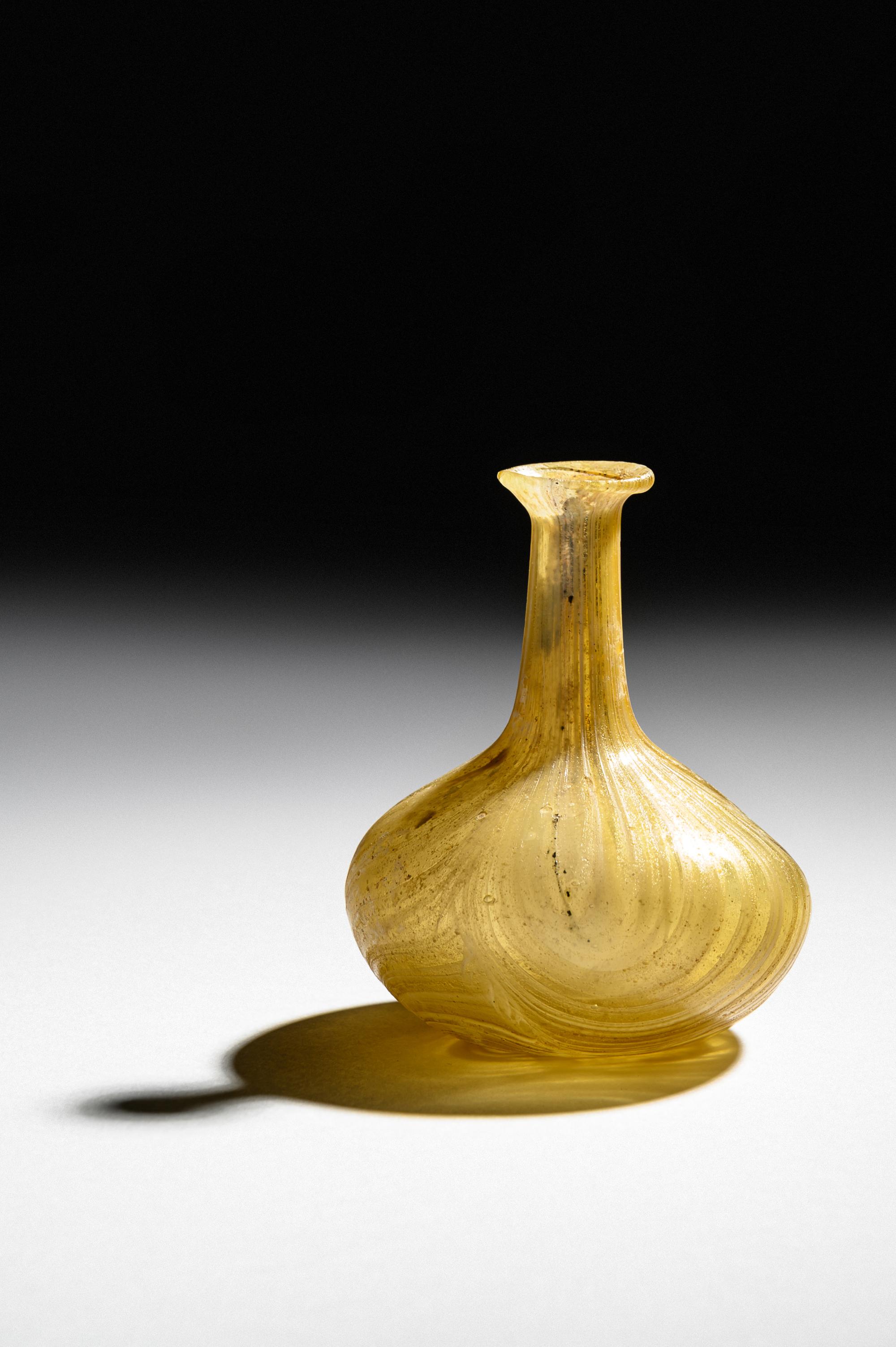 A Roman Marbled Yellow Glass Bottle