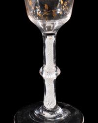 A Giles Gilt Decorated Opaque Twist Knopped Wine Glass