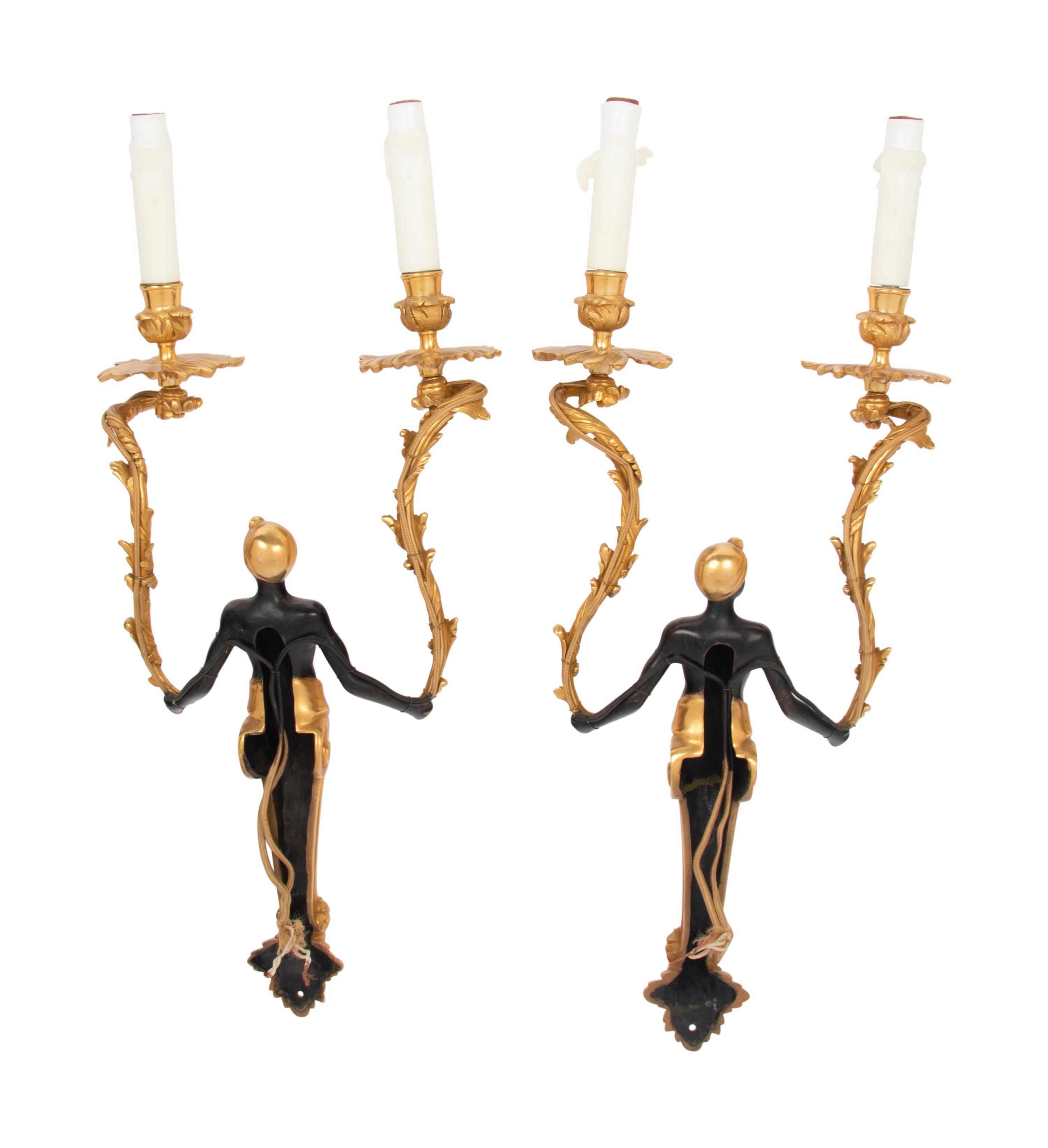 A Pair of French Gilt and Patinated Bronze Figural Two-Light Sconces