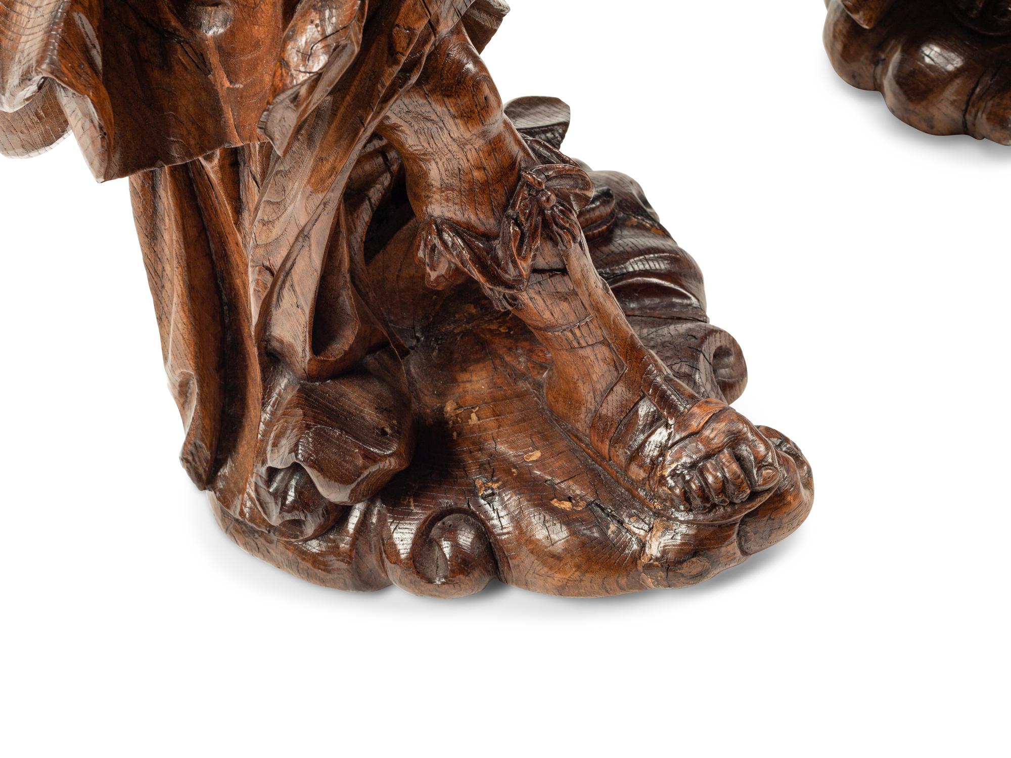A Pair of Continental Carved Wood Figural Prickets