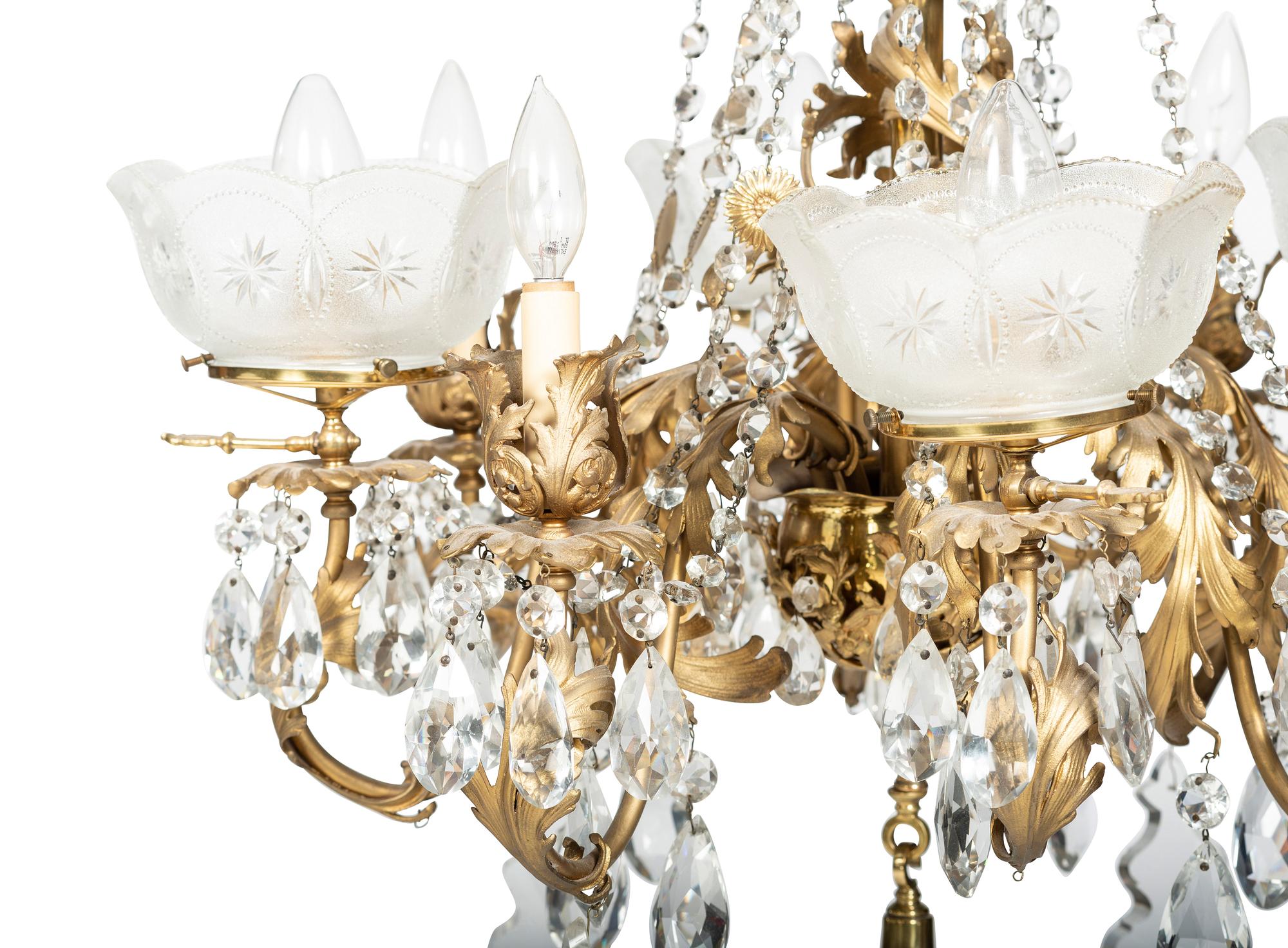A Gilt Metal Eight Light Chandelier with Etched Glass Shades