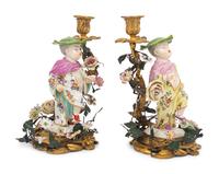 A Pair of French Porcelain, Tôle, and Gilt Bronze Figural Candlesticks