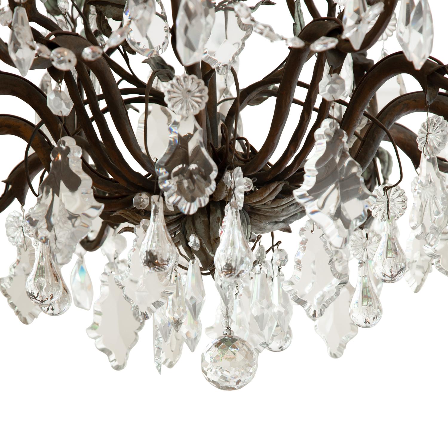 A Continental Patinated Bronze, Tole and Cut Glass Twelve-Light Chandelier