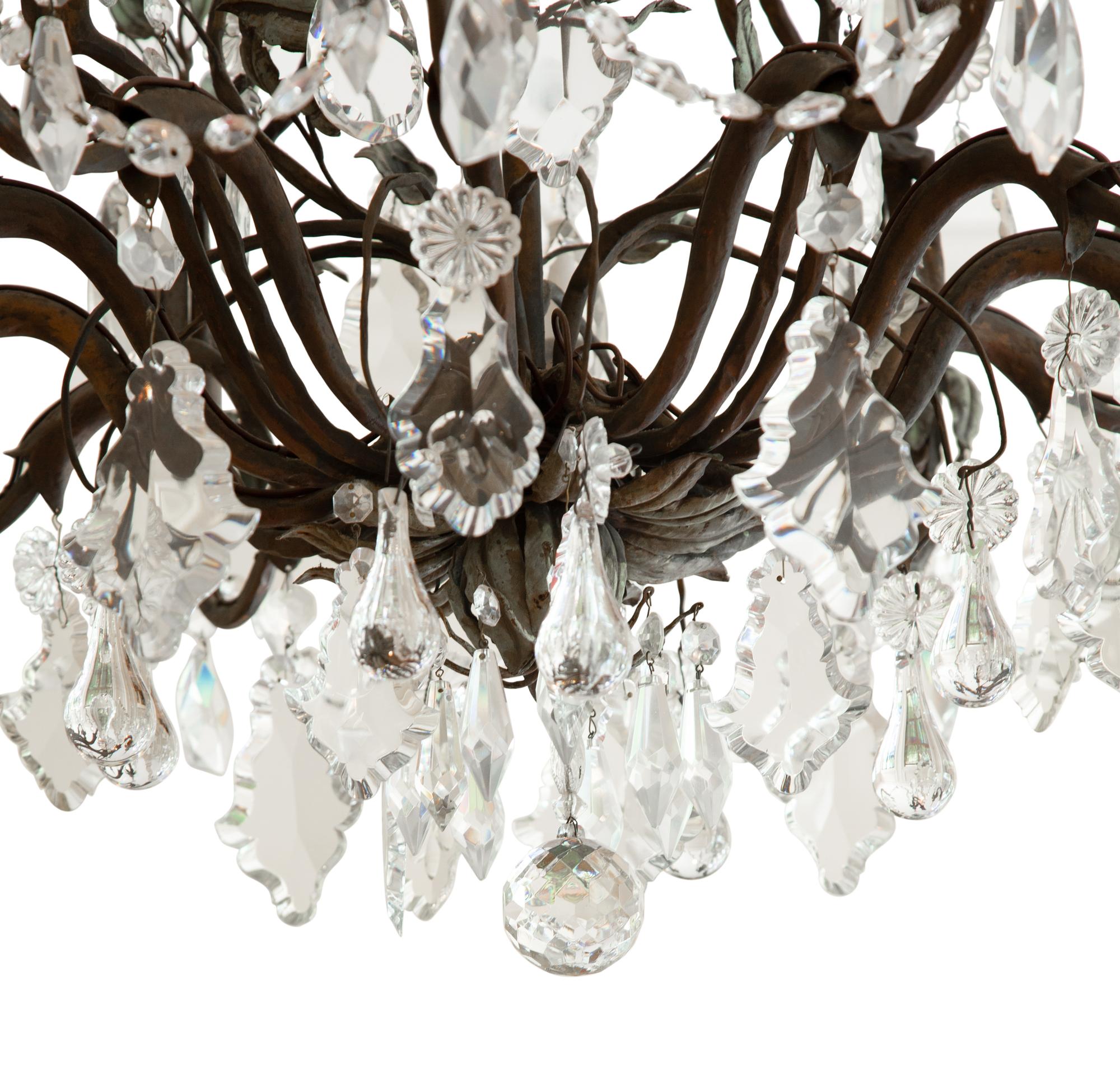 A Continental Patinated Bronze, Tole and Cut Glass Twelve-Light Chandelier