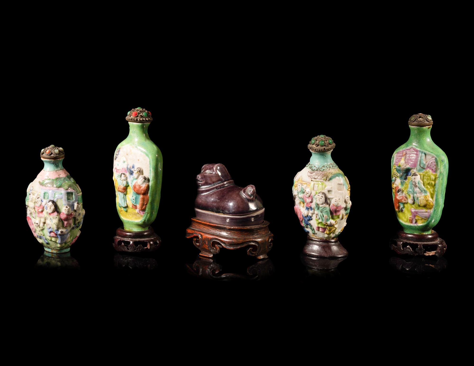 Four Chinese Famille Rose Porcelain Snuff Bottles and A Aubergine Glazed Porcelain Dog-Form Paper Weight