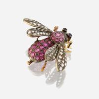 A silver topped gold, ruby, diamond, and sapphire brooch