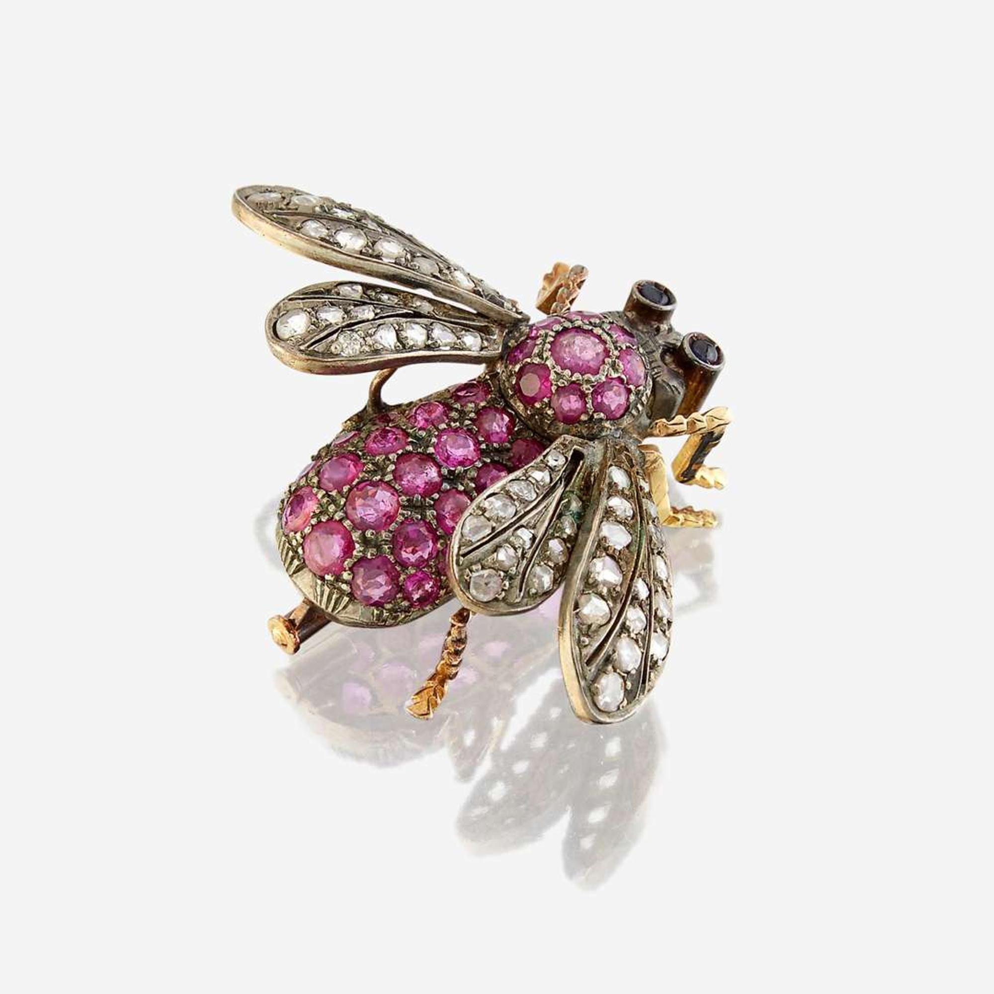 A silver topped gold, ruby, diamond, and sapphire brooch