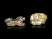 Two Chinese Pale Celadon Jade Figures of Recumbent Beasts