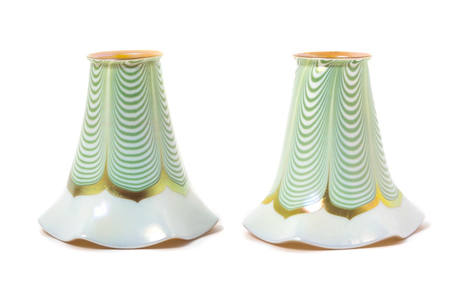Steuben, EARLY 20TH CENTURY, a pair of Aurene glass shades, with pulled feather decoration, together with a brass two-light fixture