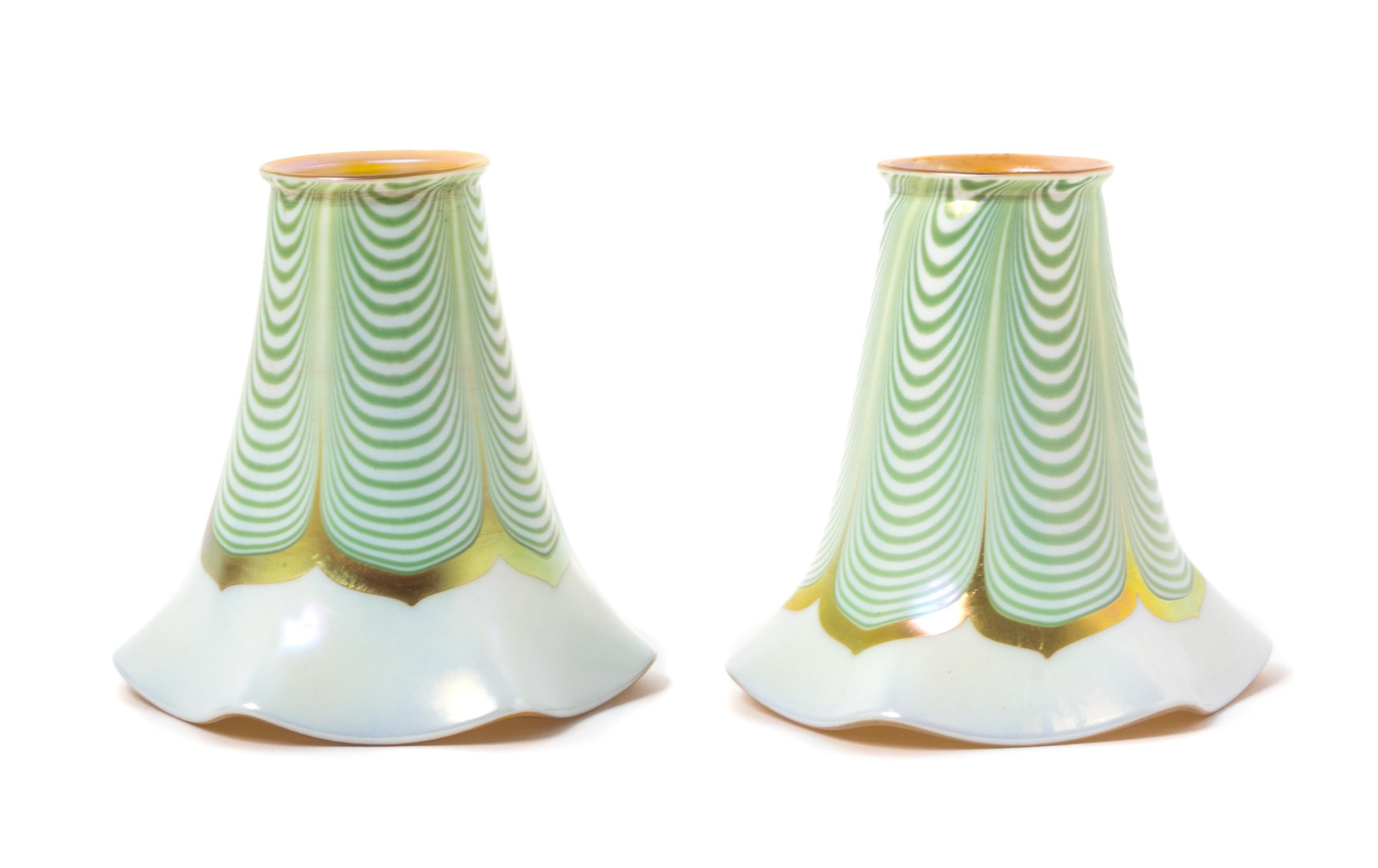 Steuben, EARLY 20TH CENTURY, a pair of Aurene glass shades, with pulled feather decoration, together with a brass two-light fixture