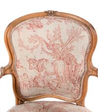 A Louis XV Carved Fruitwood Fauteuil