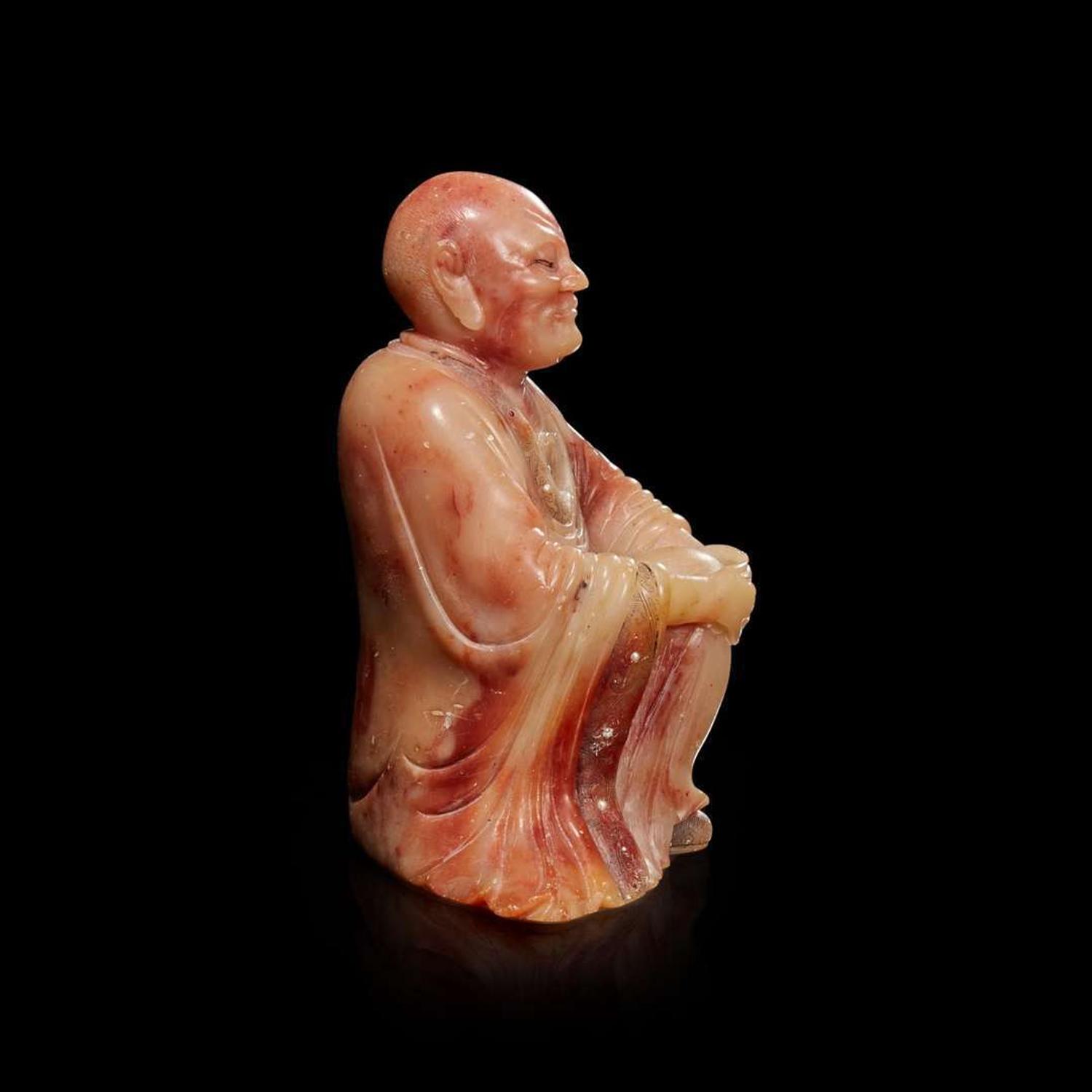 A finely-carved Chinese beige and rose soapstone figure of a seated lohan 壽山石雕羅漢 Qing dynasty, 18th/19th century ? ???????