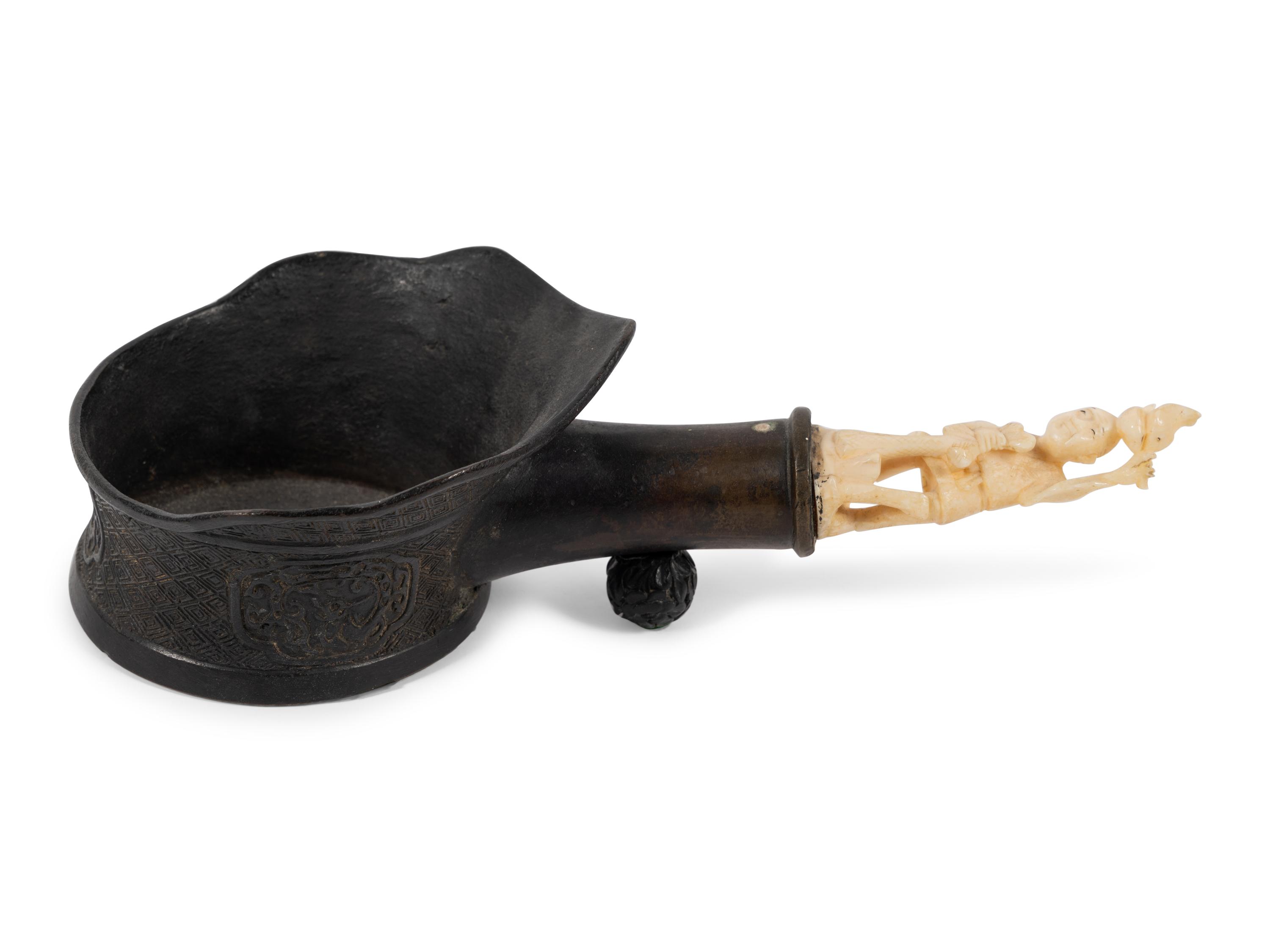 A Chinese Silk Iron with a Figural Handle