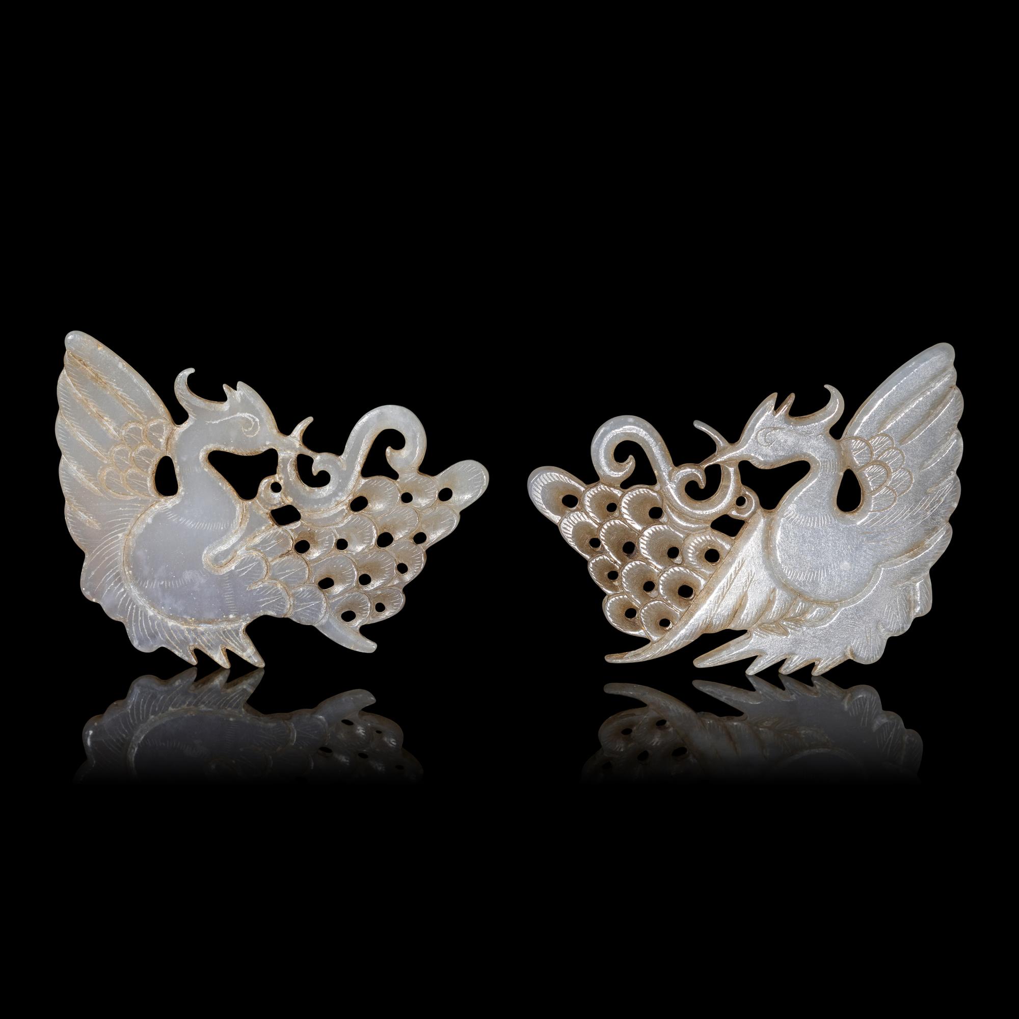 A Pair of Chinese Pale Celadon Jade 'Peacock' Hat Ornaments, Jin Dynasty 金 白玉孔雀珮一對