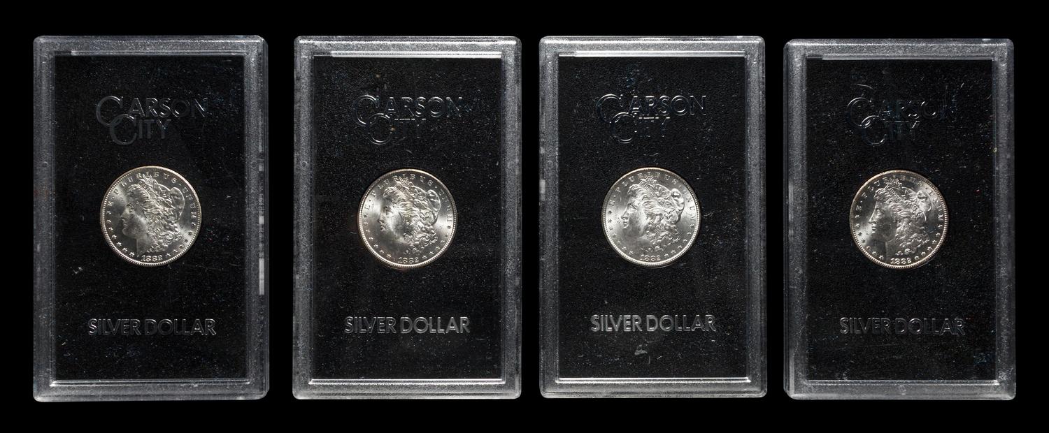 A Group of Four 1882-CC GSA: Morgan $1 Coins