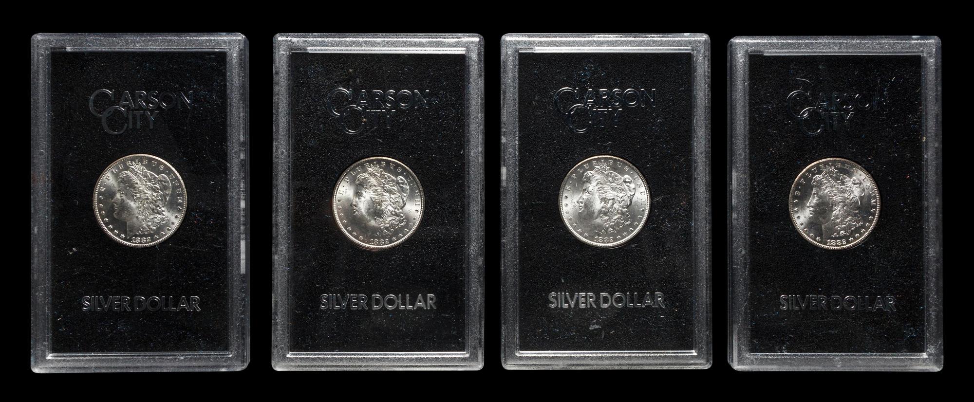 A Group of Four 1882-CC GSA: Morgan $1 Coins
